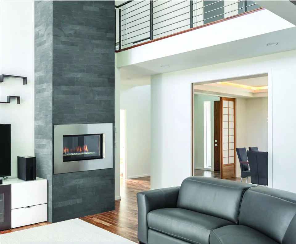 Titanium Sawcut Ledge Stone on a double-height fireplace wall